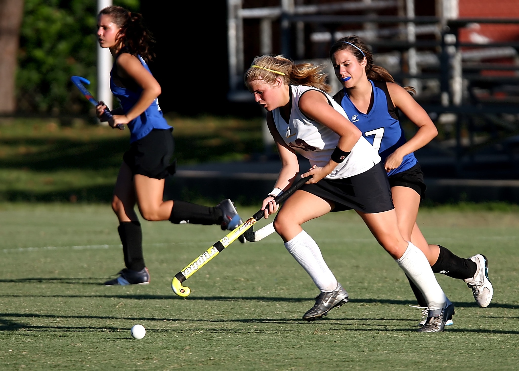 A photo of girls playing a game of hockey