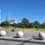 A photo of a community recreation area with a park and buildings in the background